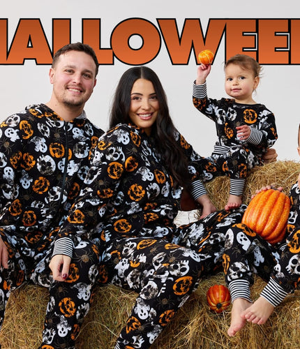 Family in matching Boo Crew Halloween pyjamas on hay bales with pumpkins