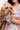 Woman holding dog in matching Sesame Street™ comic print bandana