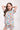 Girl with hands behind head in Sesame Street™ comic print PJ set