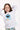 Girl with hand behind head in Cookie Monster PJ top